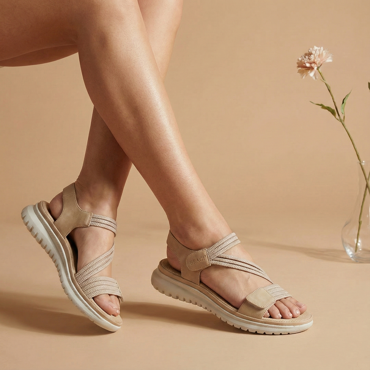 Beige sandals worn by a person on a beige background