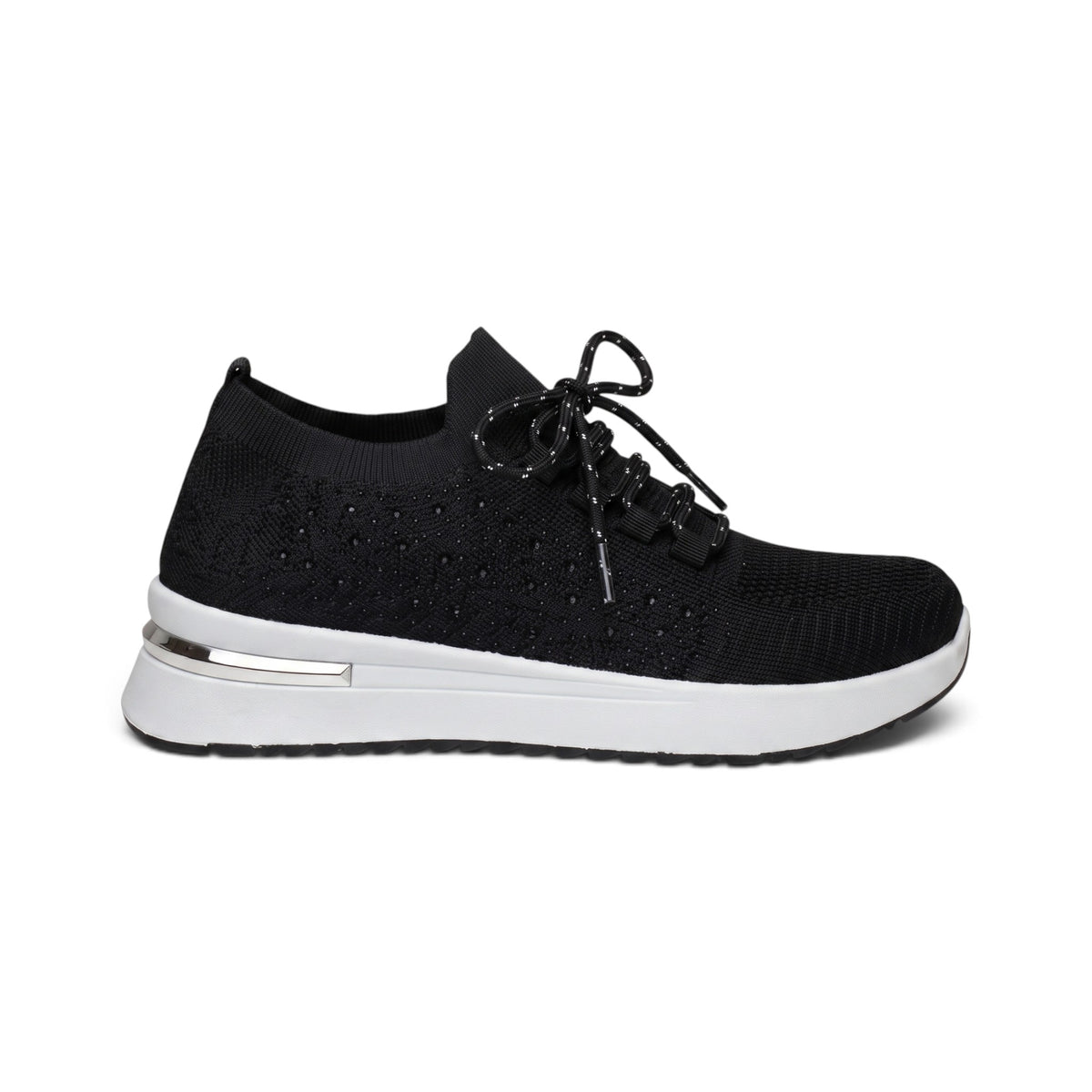 A black knit slip-on sneaker with a thick white platform sole and a metallic silver accent on the heel, shown from a side profile on a white background.
