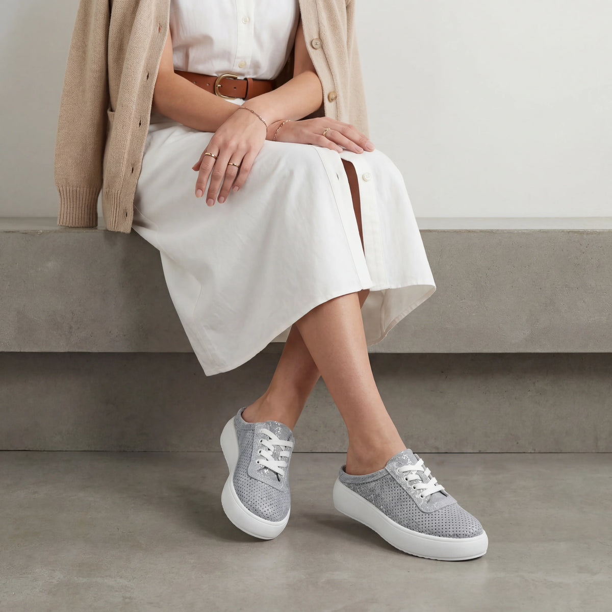 A blue and silver metallic platform mule sneaker with a perforated upper, easy slip-on design and lightweight cushioned sole for everyday comfort.