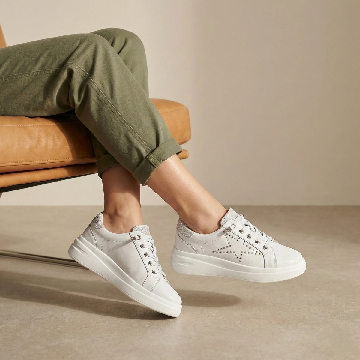 A white platform sneaker with silver studded star detailing, glitter accents and a lightweight cushioned sole for comfortable everyday wear.