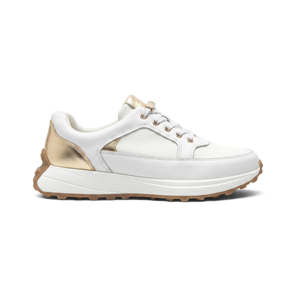 A white low-top sneaker with metallic gold accents on the heel, tongue, and eyelets, featuring a chunky white midsole and a brown gum outsole, shown in a side profile on a white background.