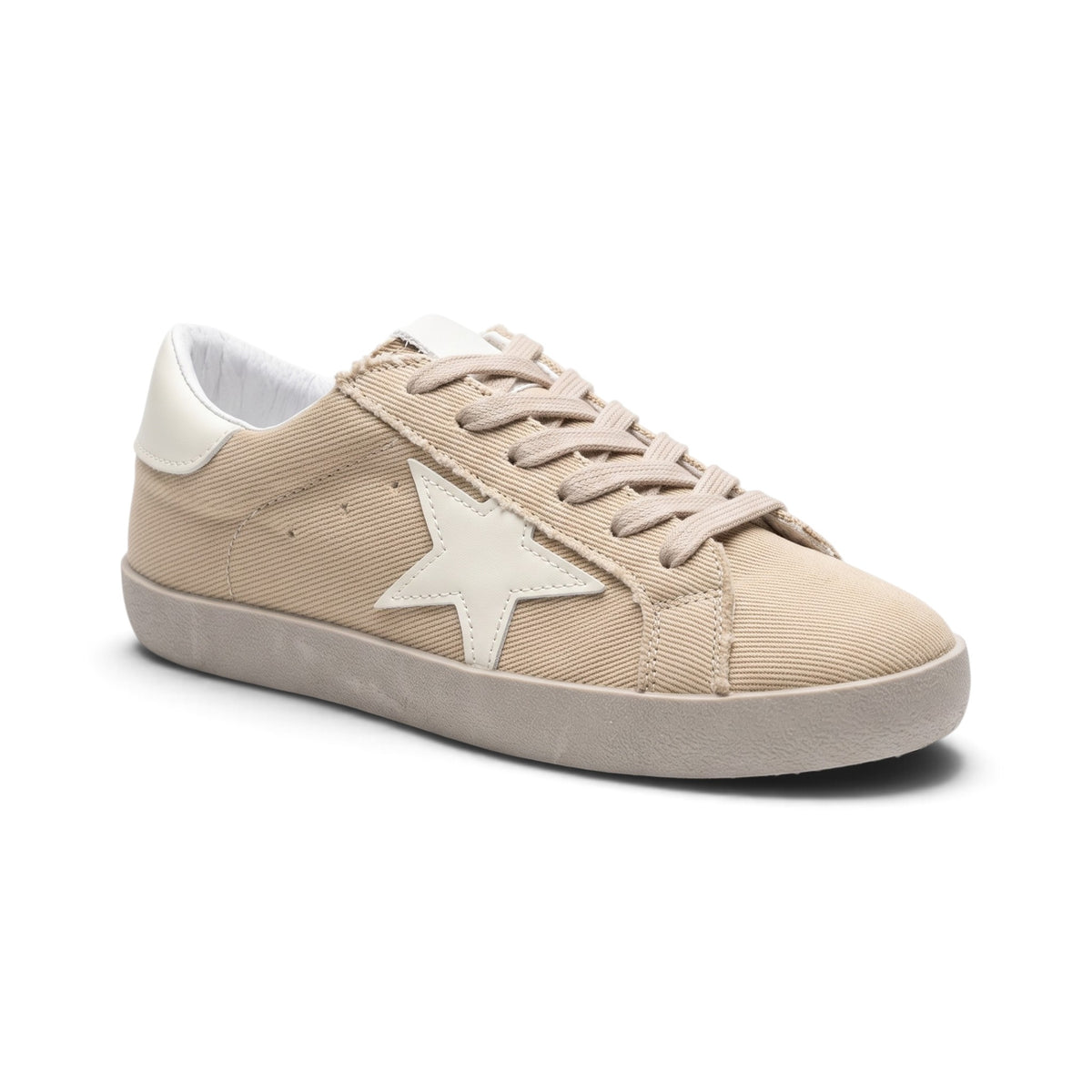 A beige canvas low-top sneaker with a white star on the side, beige laces, and a beige rubber sole, shown on a white background.